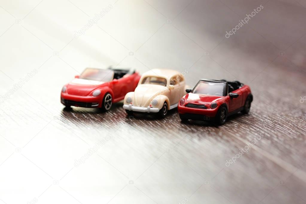 Vintage car models aligned on a wooden background