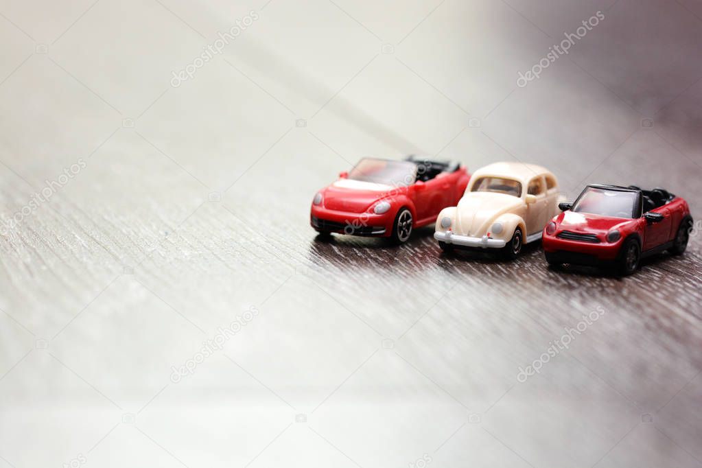 Vintage car models aligned on a wooden background