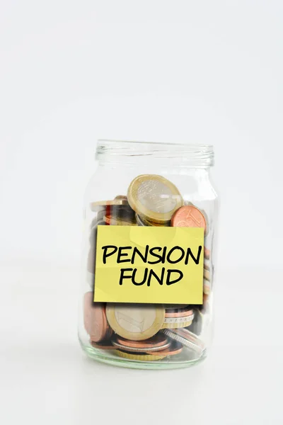 Pension fund label stuck on a glass jar filled with coins — Stock Photo, Image