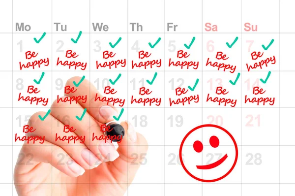 Написання в календарі, щоб бути щасливим і посміхатися більше, як бажання наступного року резолюції — стокове фото