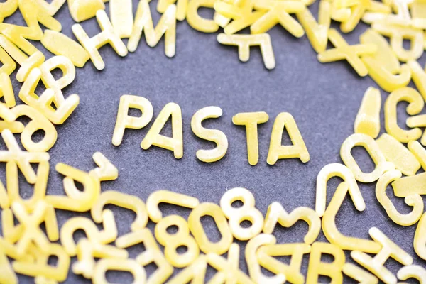 Pasta word made from letter shaped pasta or noodles — Stock Photo, Image