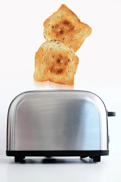 Roasted toast bread popping up of stainless steel toaster — Stock Photo, Image