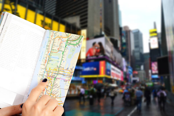 Woman hand holding a tourist map in Manhattan, New York city center