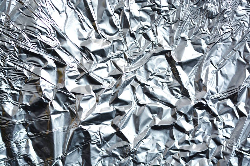 Crumpled aluminum foil texture as background