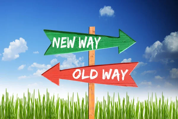 New way vs old way on wooden arrows with blue sky as background — Stock Photo, Image