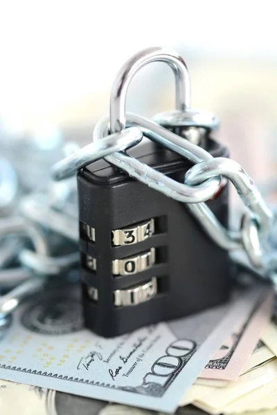 financial security concept with chain and padlock on cash banknotes