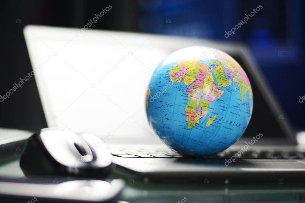 Global business or international affairs concept with colorful Earth globe on computer keyboard