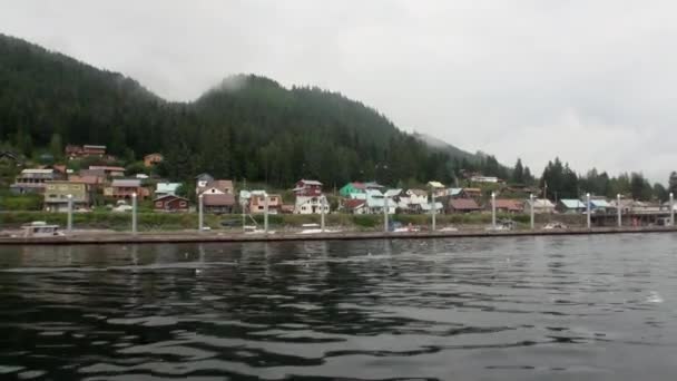 Wharf for boats on calm water of Pacific Ocean on background coast in Alaska. — Stock Video