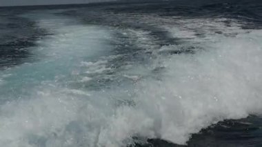 Endonezya'da deniz ufuk çerçevede bir motorlu tekne dalgalardan.