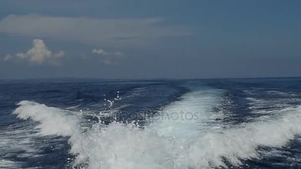 Waves from a motor boat against a background of the sea horizon in Indonesia. — Stock Video