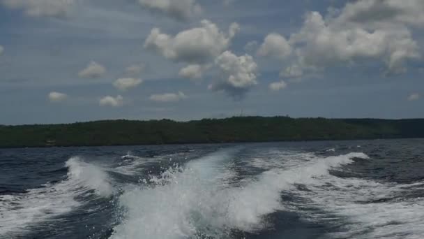 Waves from a motor boat against a background of the sea horizon in Indonesia. — Stock Video