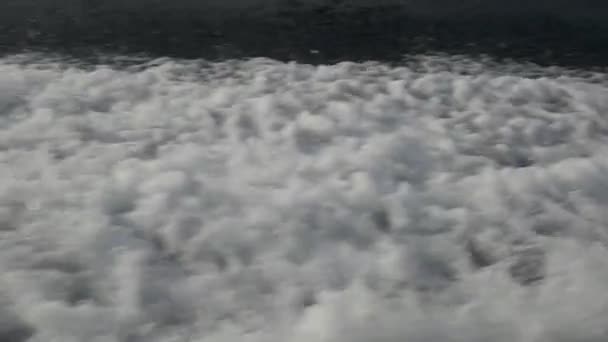 Waves from a motor boat against a background of the sea horizon in Indonesia. — Stock Video