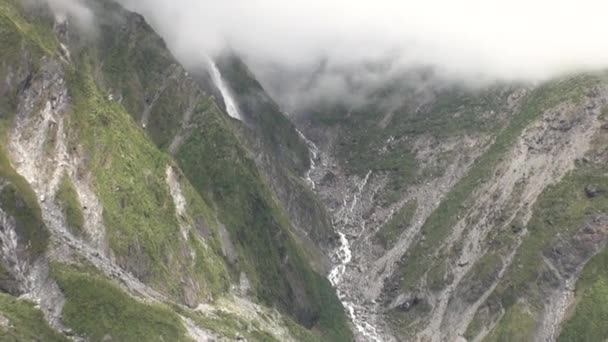 Persone turisti tra le montagne verdi e innevate . — Video Stock