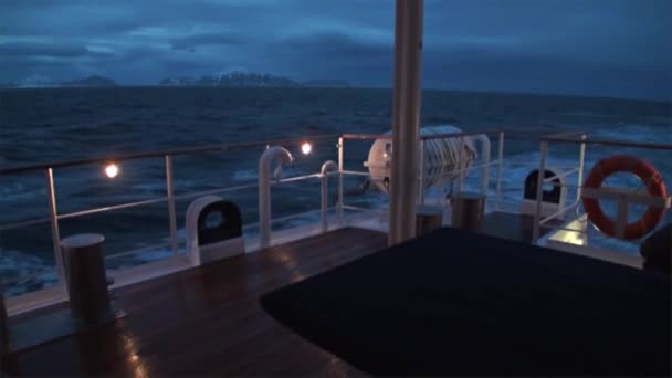 Retour du navire la nuit sur fond de montagne sur l'eau de l'océan Arctique .