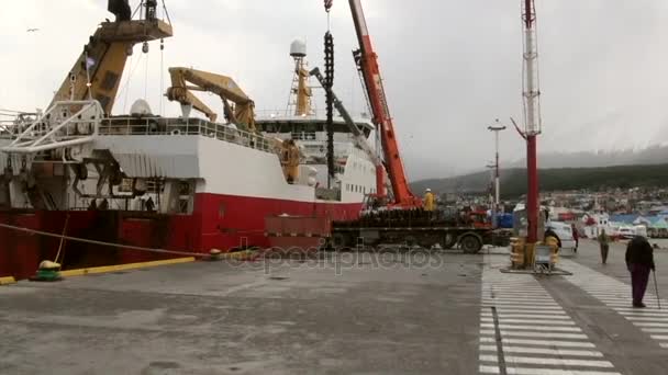 Cargo ship and people in port harbor of Ushuaia Argentina. — Stock Video