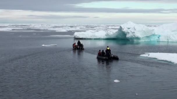 Divers pływać w ponton na tle gór lodowych, lód, w Ocean Arktyczny. — Wideo stockowe