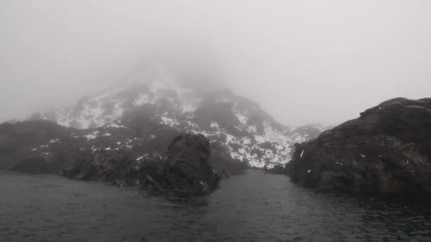 Snö berg och steniga klippor i dimma av Arktiska oceanen i Svalbard. — Stockvideo