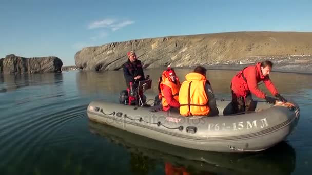 Pessoas em um barco de borracha em Ocean on New Earth Vaigach . — Vídeo de Stock