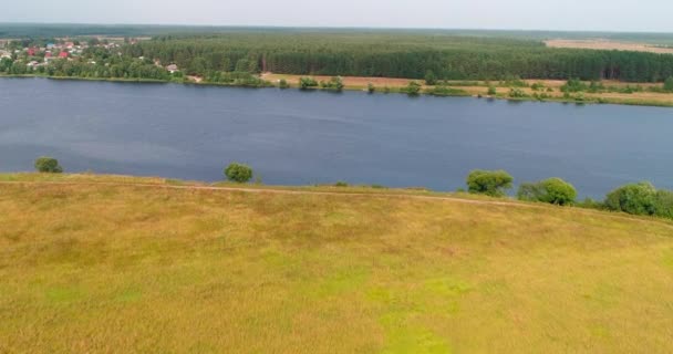 Arable landon Volga river aerial view from flying quadcopter over forest. — Stock Video