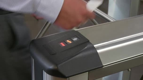 Hands of people apply electronic pass to turnstile wicket checkpoint in office. — Stock Video