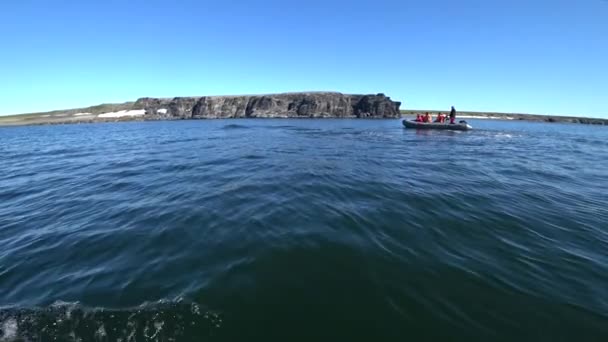 People in rubber boat near coast of Arctic Ocean on New Earth Vaigach Island. — Stock Video