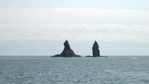 Havet vågor vatten ytan på gröna steniga klippor kust strand i Japan havet. — Stockvideo