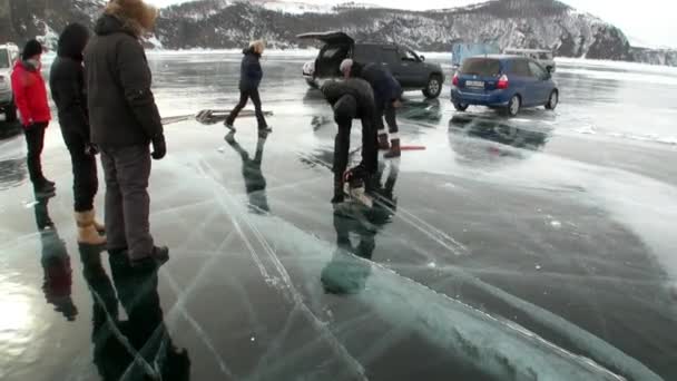 As pessoas estão se preparando para cortar gelo para buracos de gelo em Baikal . — Vídeo de Stock