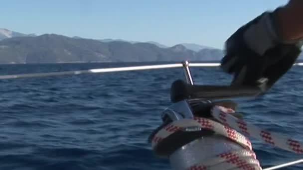 Ручные повороты веревки на движущейся парусной яхте . — стоковое видео