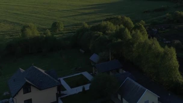 Krásný výhled na panorama vesnice s domy a zahradami na řece obklopené zelenými pastvinami s nádhernými krajinnými filmovými výhledy. Koncept podnebí venkovní příroda. — Stock video