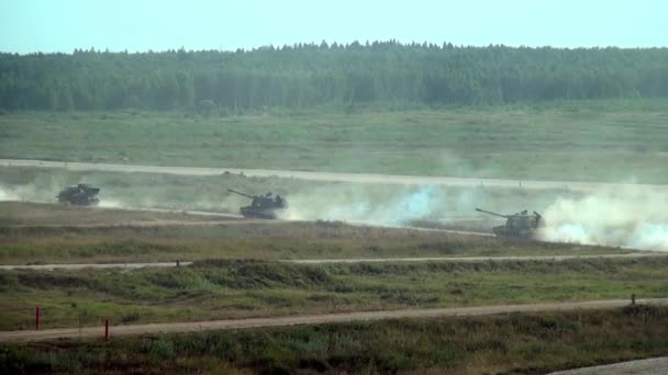 Russian column of military vehicles and tanks in field at exercises. — Stock Video