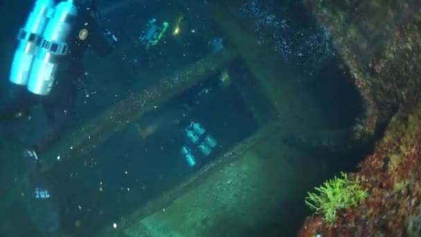 Diver inside wreck underwater in Truk Lagoon. — Stock Video