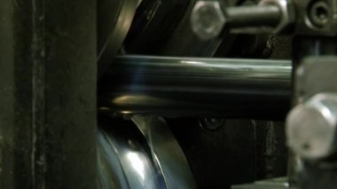 Fabrikadaki çelik borulardan oluşan metal rulo makineler üzerine yakın çekim metaller..