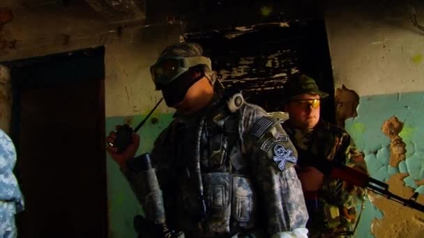 Airsoft-Militärspieler in Militäruniformen spielen in zerstörten Gebäuden. — Stockvideo