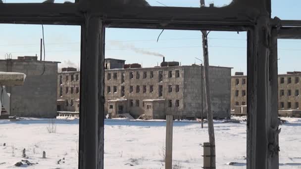 Schnee im zerbrochenen Fenster eines verlassenen Hauses in einer verlassenen Stadt. — Stockvideo