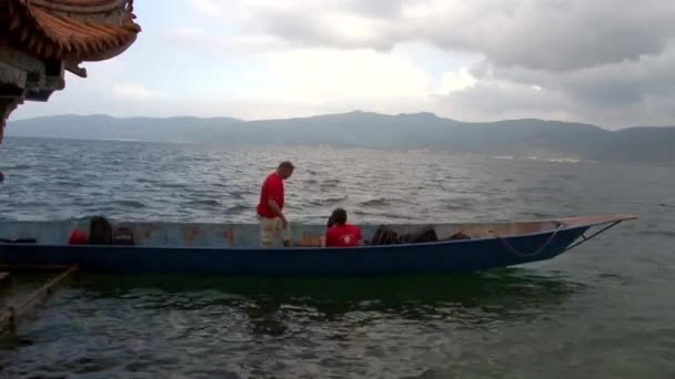 Personas en barco chino sampan cerca de gazebo con estilo chino. — Vídeos de Stock