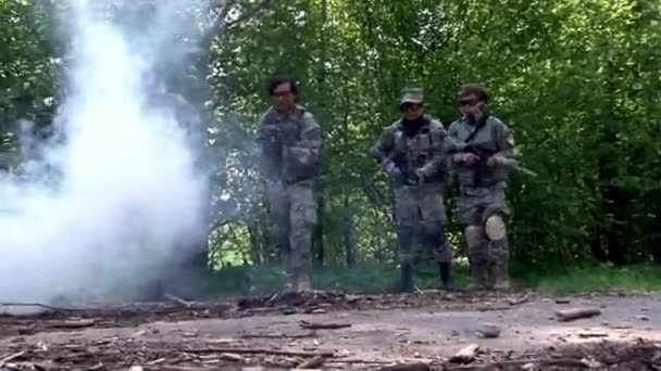 Airsoft speler in militair uniform met wapen in het bos. — Stockvideo