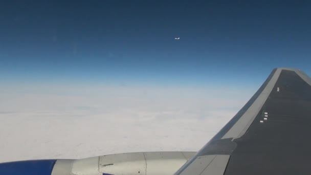 Airplane wing view from window of plane flying in winter. — Stock Video