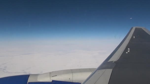 Airplane wing view from window of plane flying in winter. — Stock Video