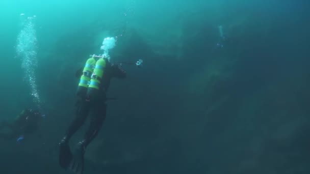 Camarógrafos de buceo con grupo nadando bajo el agua en el lago Baikal . — Vídeos de Stock