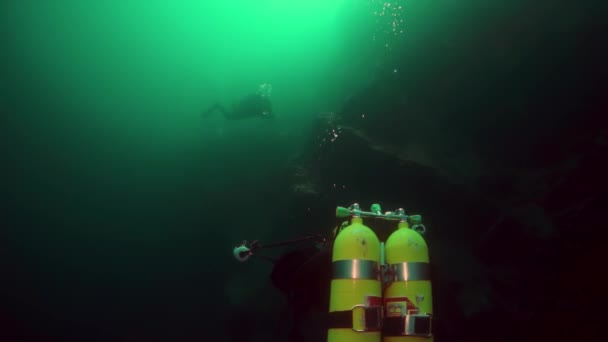 Scuba duiker cameramensen met groep zwemmen diep onder water in het Baikalmeer. — Stockvideo