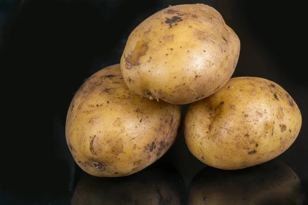 Kartoffeln auf einem schwarzen — Stockfoto