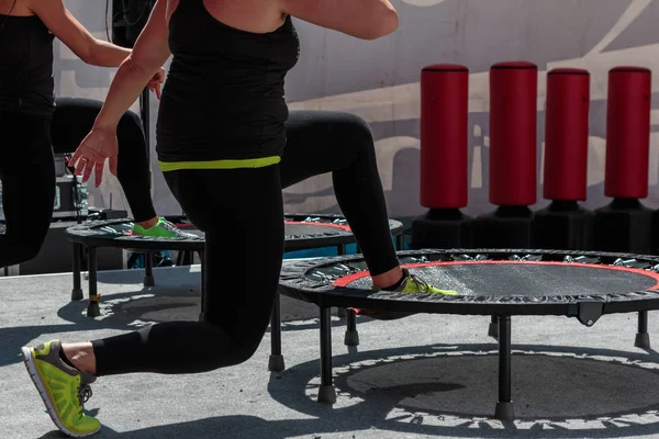 Mini Trampoline Workout: Girl doing Fitness Exercise in Class at