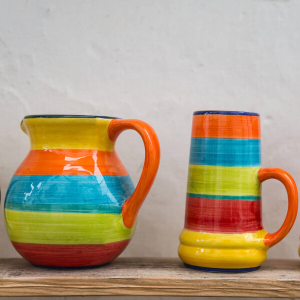 Colorful Empty Cups on Wooden Shelf