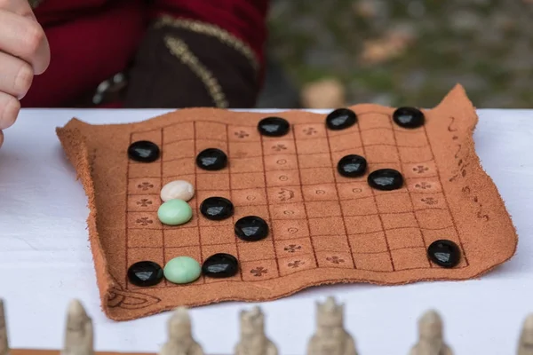 Antikes Tischspiel mit ovalen Figuren und braunem Stoffbrett — Stockfoto