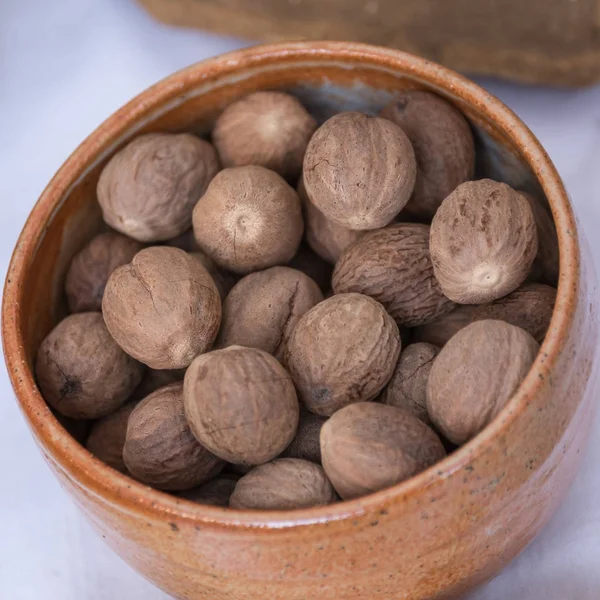 Nutmegs inside a Clay Bowl, Aromatic Seed — Stock Photo, Image