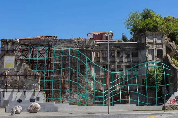 Edifícios destruídos e muralhas com luta artística verde no Porto, Portugal — Fotografia de Stock