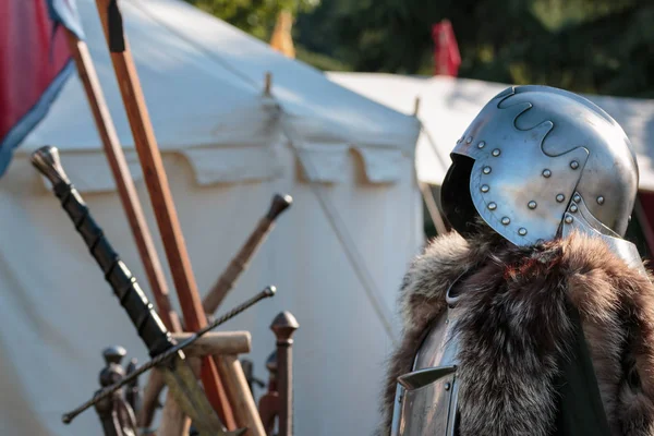 Medieval Iron Helmet, Metallic Armor and Fur Coat, Swords And White Tent in background — Stock Photo, Image