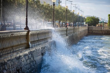 Rüzgarlı bir gün içinde bir yol Parapet karşı kırma dalgalar deniz: fırtınalı hava