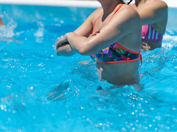 Women Doing Water Aerobics Outdoor in a Swimming Pool