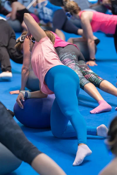 Girls doing Fitness Exercises outstretched on Big Ball at Gym — Stock Photo, Image